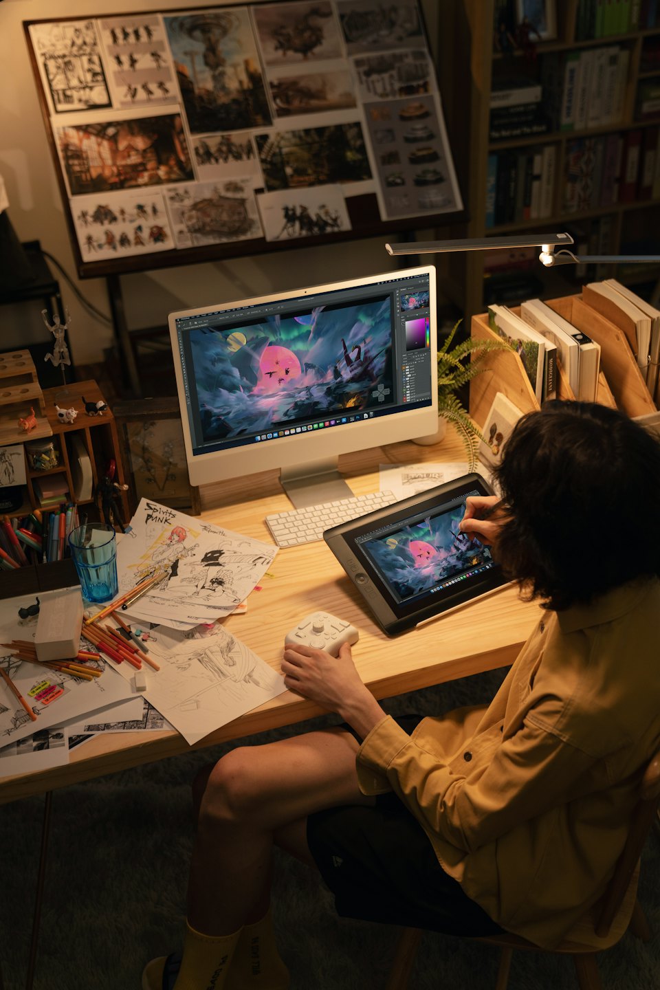 Artist draws a fantasy illustration on a digital tablet.